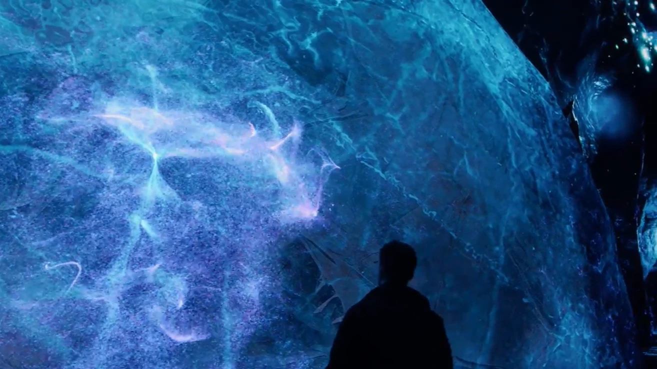 A visitor interacting with animated Antarctic krill across Outernet’s screens