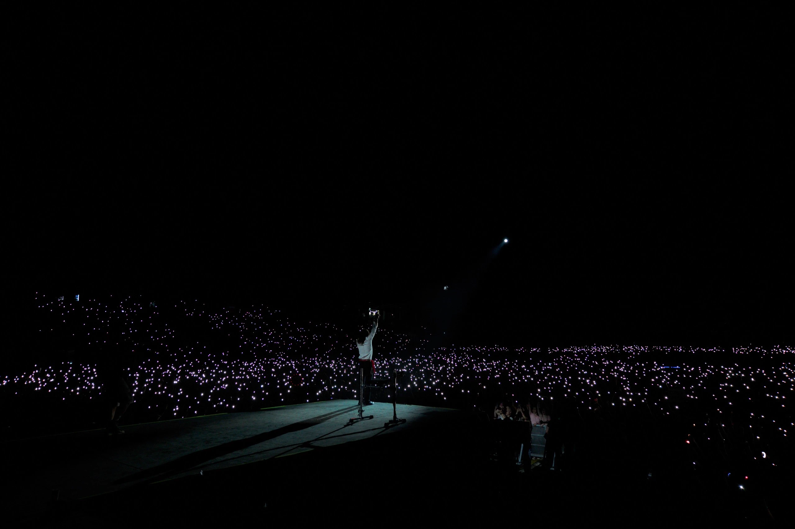 Jared Leto on the runway surrounded by an audience holding thousands of phone lights