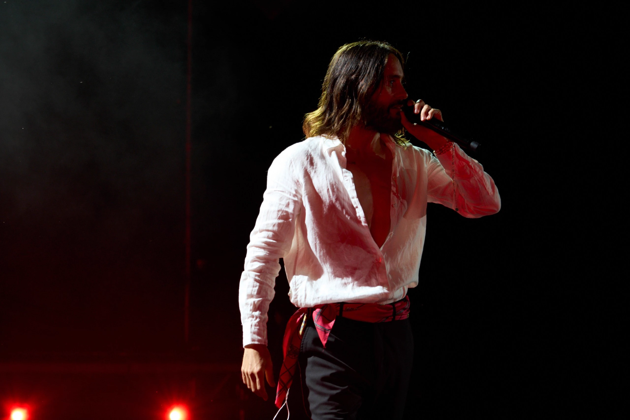 Jared Leto on stage under red light